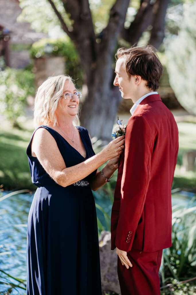 mother of the groom and groom, groom in maroon suit
