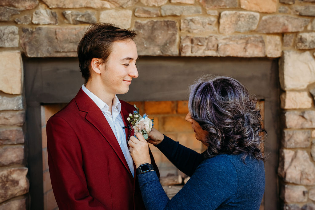 mother of the bride and groom. placing boutonniere 