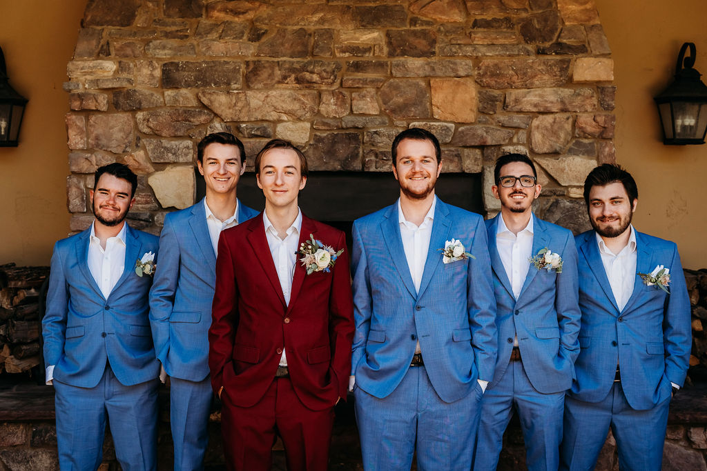 Groomsmen in powder blue suit, groom in maroon suit