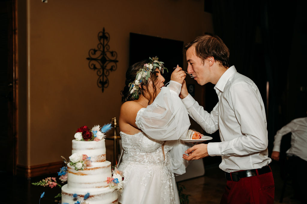 windmill house, chino valley arizona, wedding reception, bride and groom eating cake