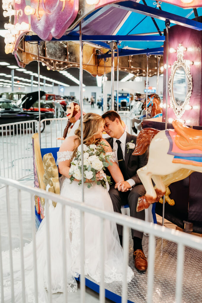 bride and groom portraits, wedding couple portraits, wedding portraits and carousel, carousel, martin auto museum events, martin auto museum wedding, classic cars