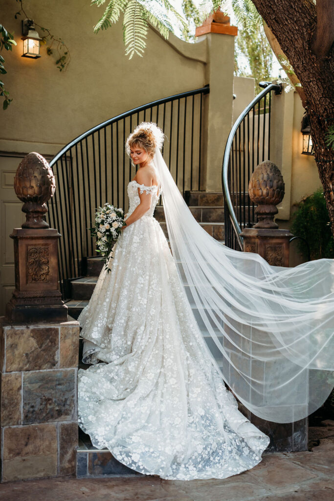 bride on steps, bride with long wedding veil, wedding dress long train and veil, wedding dress detailed floral, outside wedding reception, wright house wedding