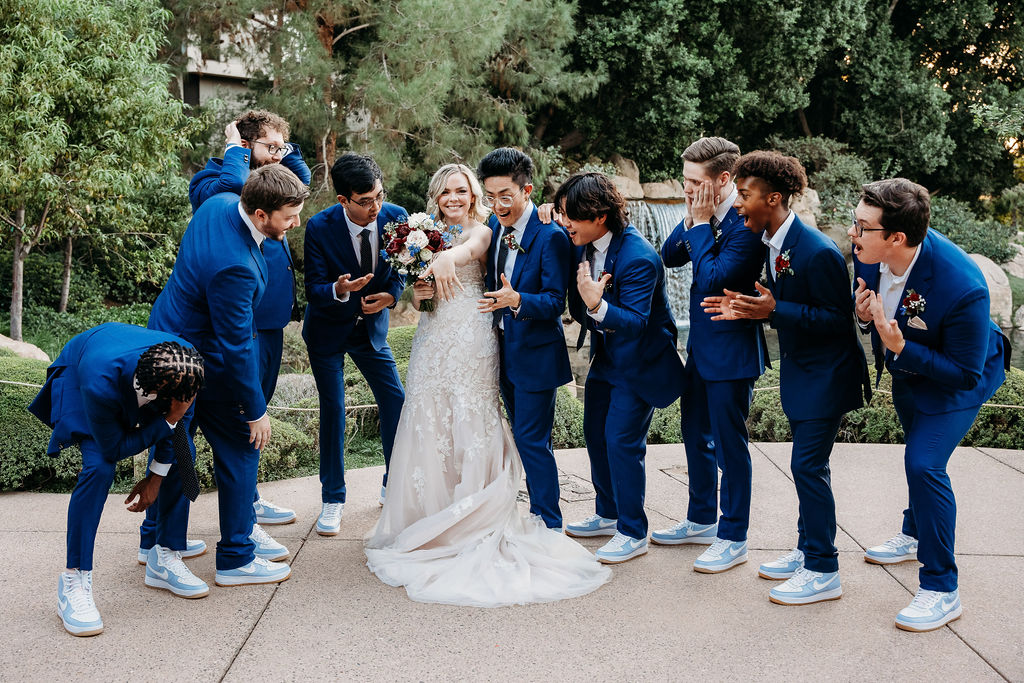 bride with groomsmen portraits at Japanese Friendship Garden Arizona. bridal party in maroon dresses, groomsmen in navy blue tux