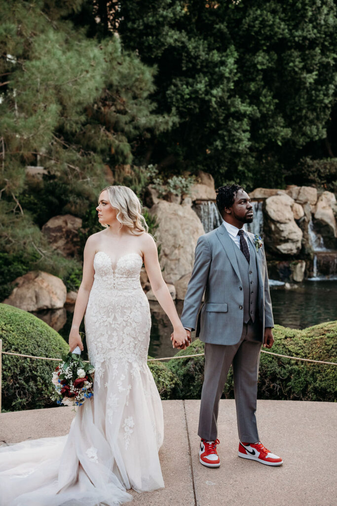 Bride and groom portraits at Japanese Friendship Garden Arizona. sweetheart cut wedding dress, groom in grey tux, wedding couple poses