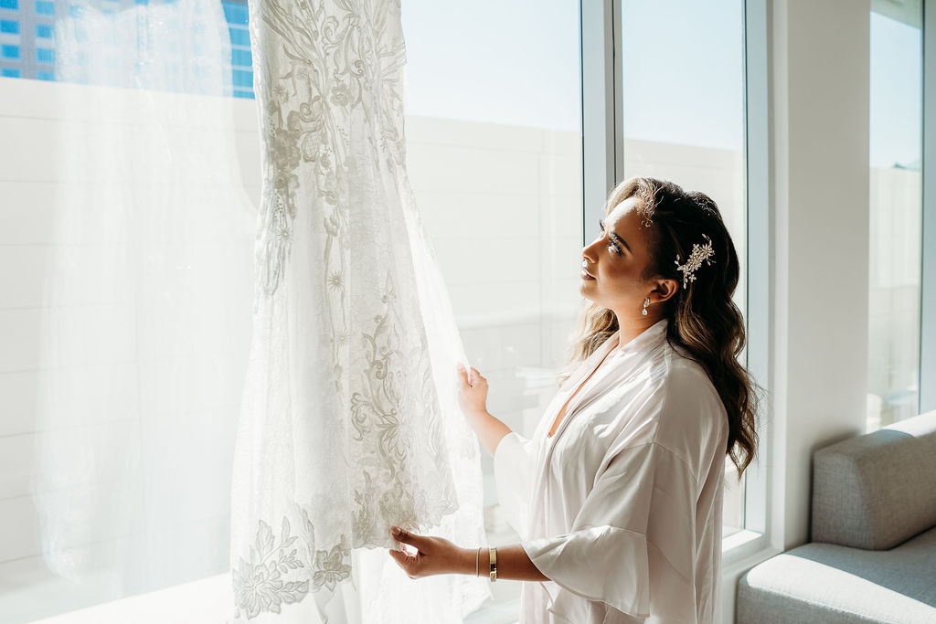 bride looking at lace detailed wedding dress, arizona wedding photographer, The Westin Tempe