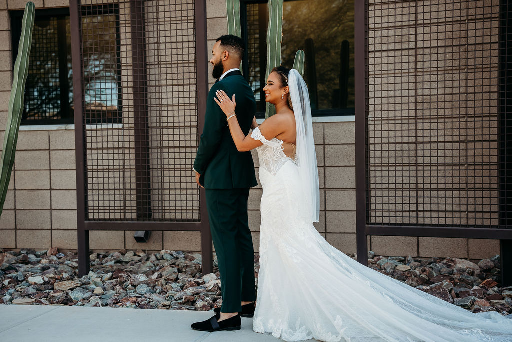 first touch with groom, forest green tux, cactus wedding portrait, first look ideas