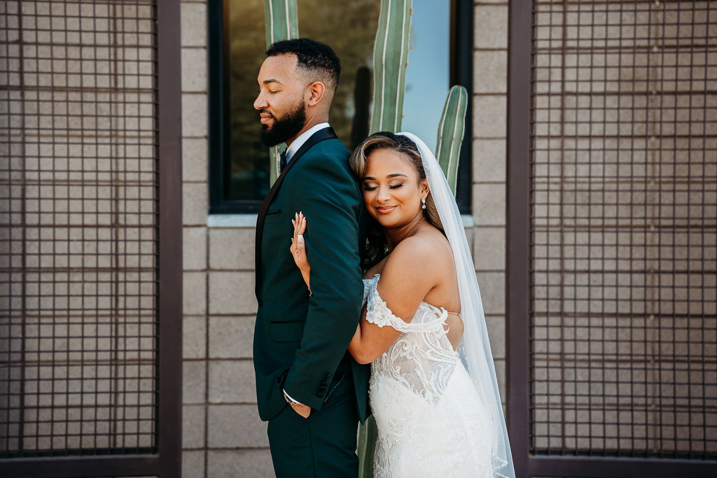 first touch with groom, forest green tux, cactus wedding portrait