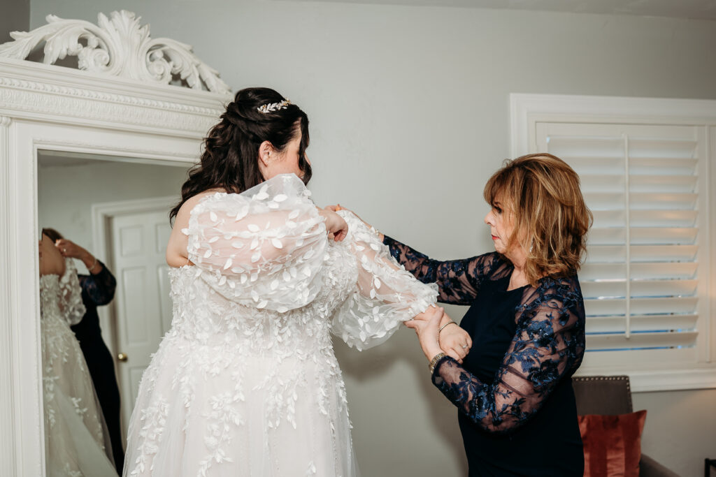 Bride getting ready, arizona wedding photographer. Sweetheart wedding dress with delicate puff shoulder sleeves with intricate leaf details.