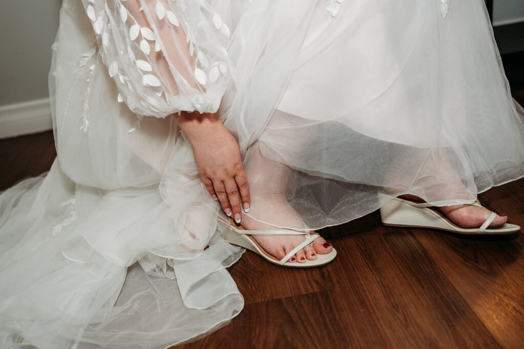 Bride getting ready, arizona wedding photographer. Sweetheart wedding dress with delicate puff shoulder sleeves with intricate leaf details.