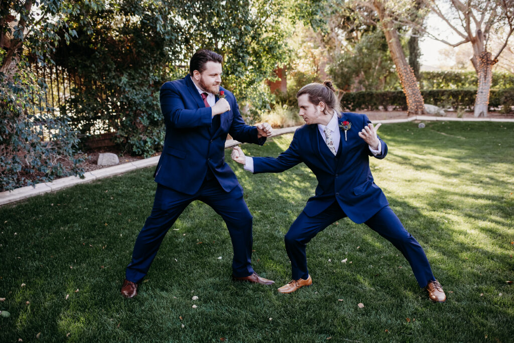 Groom and groomsmen in navy blue suit with maroon tie at Stonebridge Manor. 