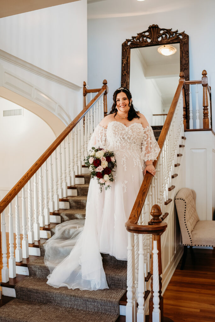 Bride getting ready, arizona wedding photographer. Sweetheart wedding dress with delicate puff shoulder sleeves with intricate leaf details. Bridal portraits on staircase.