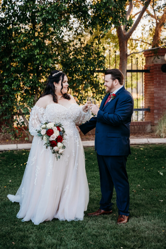 Bride and groom toasting with champagne. Arizona wedding photographer.