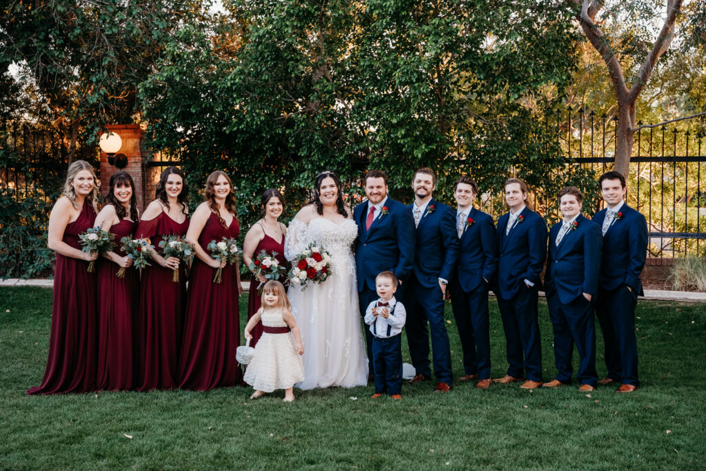 Wedding party posing. Wedding colors of navy and maroon. Stonebridge Manor. 