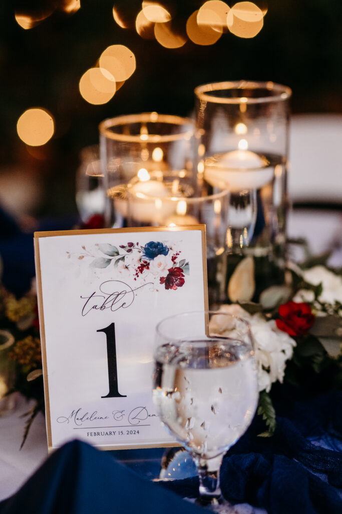 Wedding details at Stonebridge Manor. Wedding table setting of navy blue and maroon. 