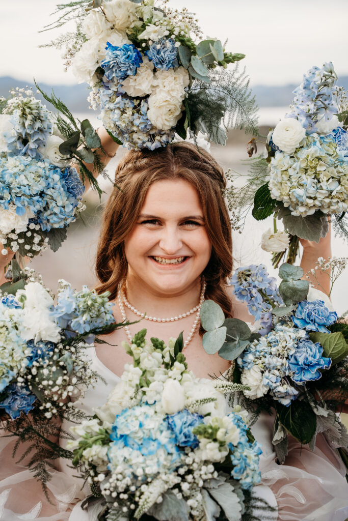 Desert Outdoor Center at Lake Pleasant, bridal portrait poses with bouquet around brides face, white roses with blue hydrangea and baby breath bouquets