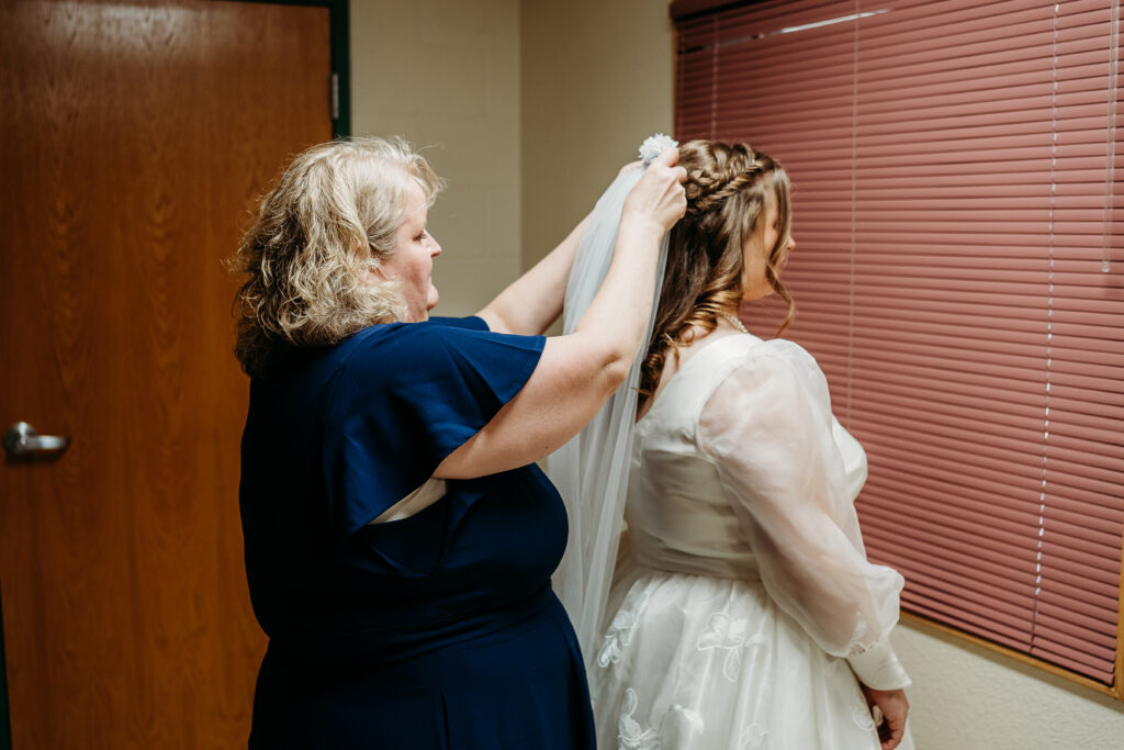 Bride getting ready at Bride first look with bridesmaids, white roses and blue hydrangea bouquet