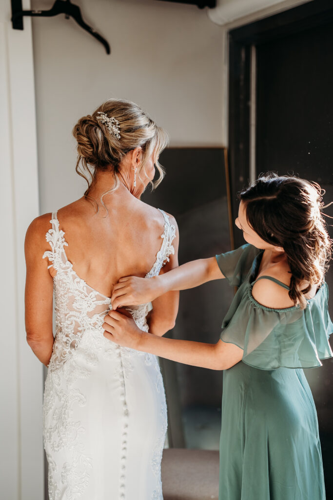 bride getting ready, arizona wedding photographer, sleeveless lace gown with a deep V-neckline