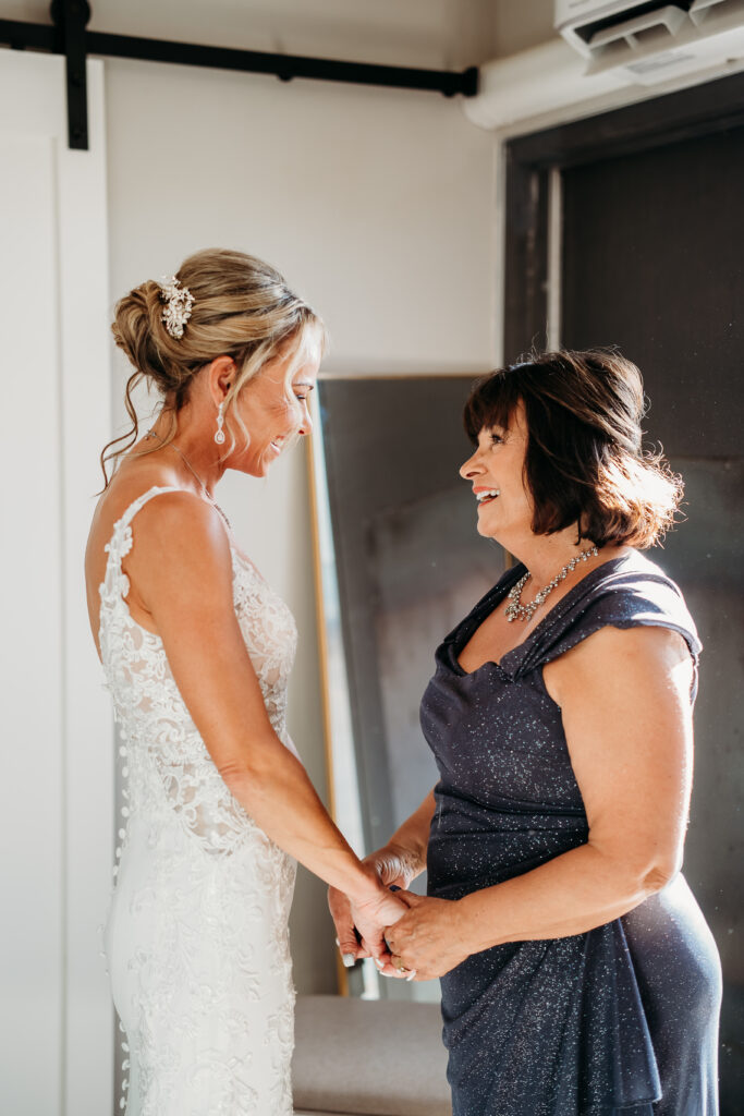 bride getting ready, arizona wedding photographer, sleeveless lace gown with a deep V-neckline