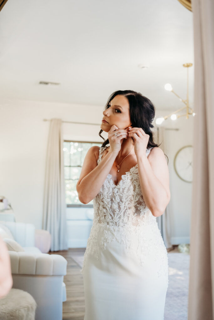 Bride getting ready at the secret garden, arizona wedding photographer, The fitted v-neck gown featured delicate lace appliqués 