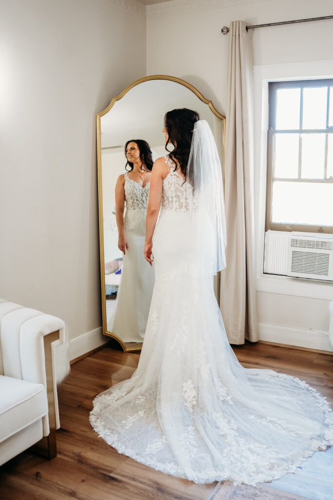 Bride getting ready at the secret garden, arizona wedding photographer, The fitted v-neck gown featured delicate lace appliqués 