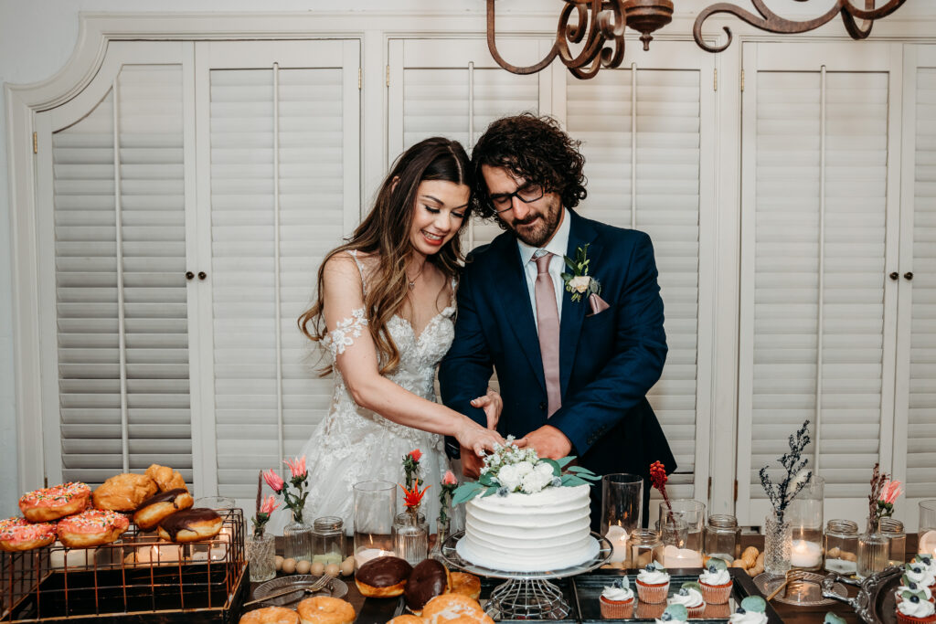 cutting the cake, bride and groom, dessert table for reception