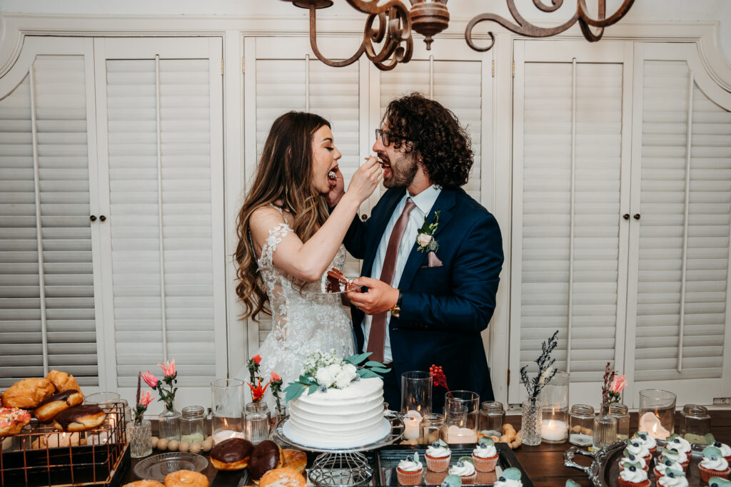 cutting the cake, bride and groom, dessert table for reception