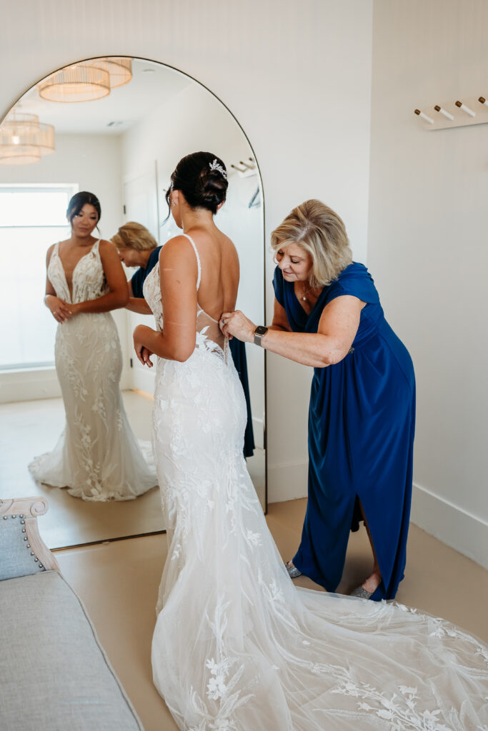 mother of bride and bride getting ready, arizona wedding photographerm deep v neck wedding dress with floral details