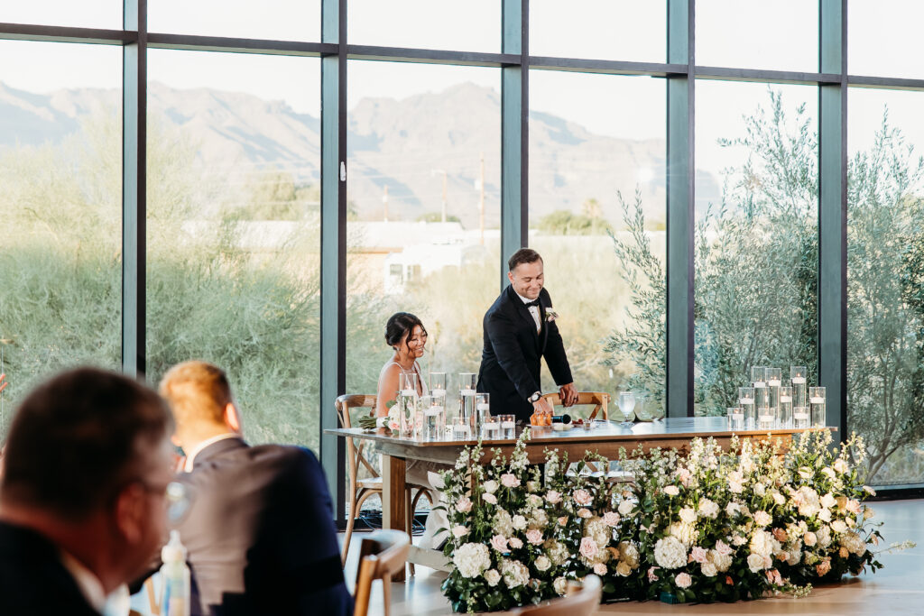 Desert View Weddings & Events reception, bride and groom sweetheart table, pink and white roses wedding florals with floating candles