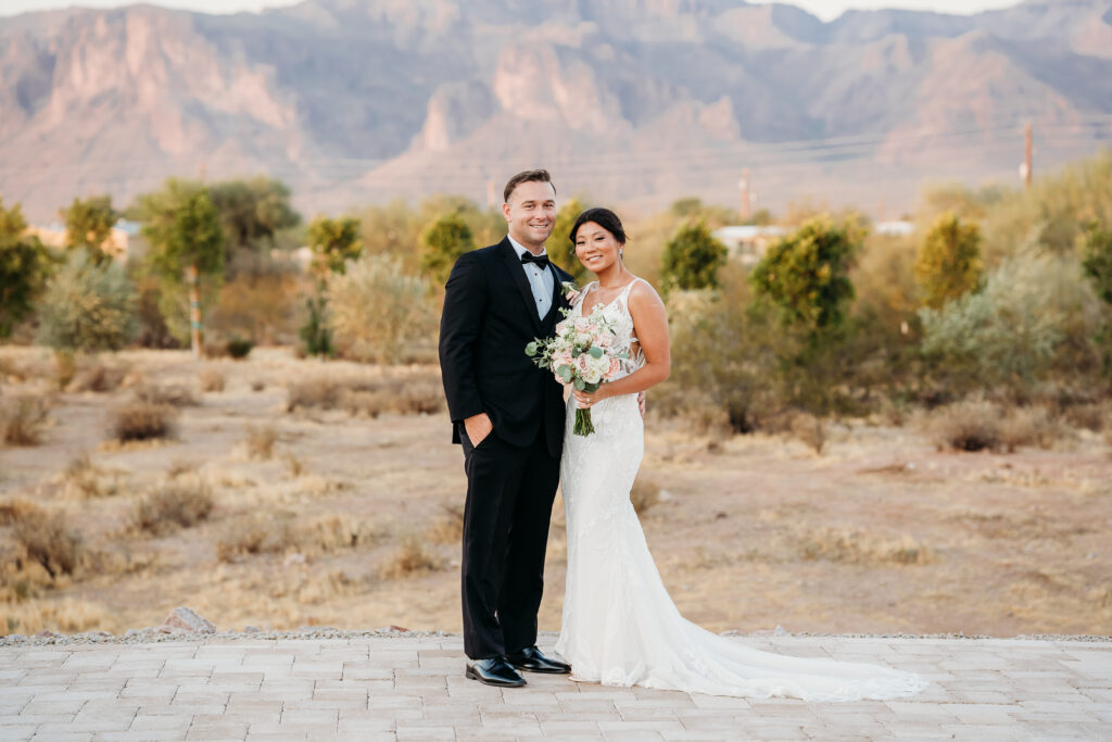 Desert View Weddings & Events, arizona desert wedding, bride and groom formals, bride and groom posing ideas, superstition mountains, deep v neck wedding dress with floral details