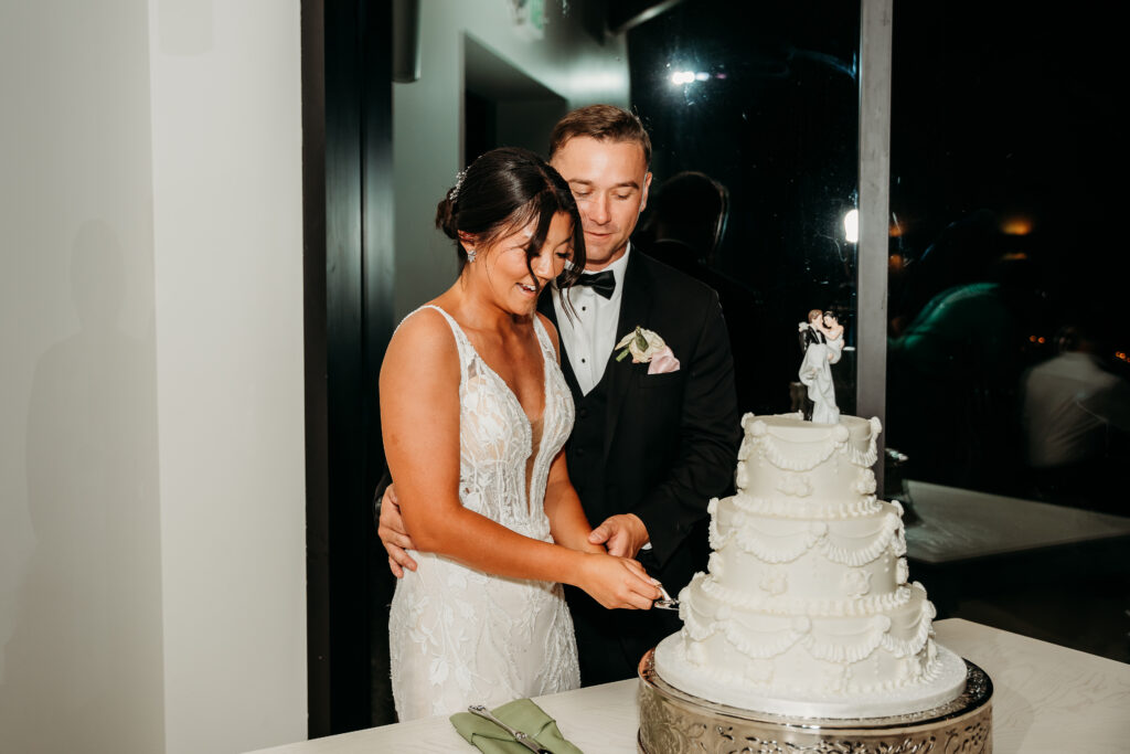 Desert View Weddings & Events Reception, bride and groom cutting the cake,3 tiered white cake