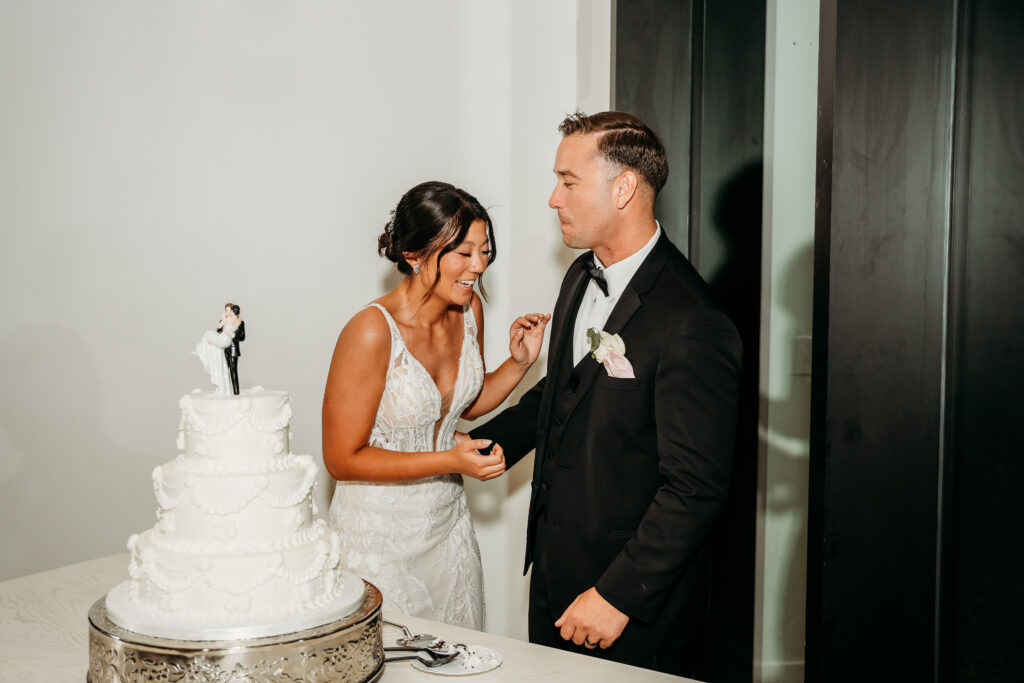 Desert View Weddings & Events Reception, bride and groom cutting the cake,3 tiered white cake