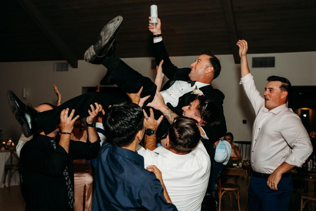 Desert View Weddings & Events Reception, groom being thrown in air, wedding reception dancing, military wedding