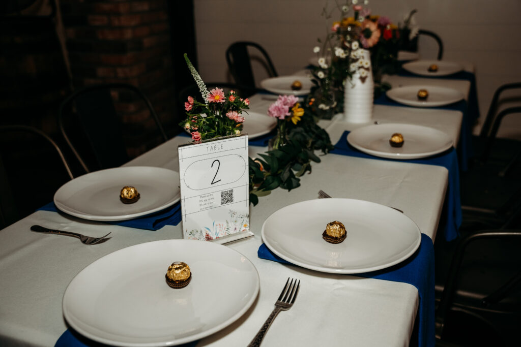 Fire House Event Center reception in Arizona, arizona wedding photographer, table decor of navy blue linens and bright flowers