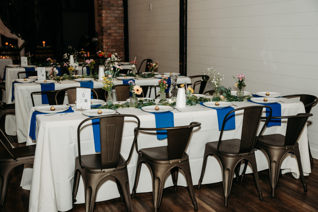 Fire House Event Center reception in Arizona, arizona wedding photographer, table decor of navy blue linens and bright flowers