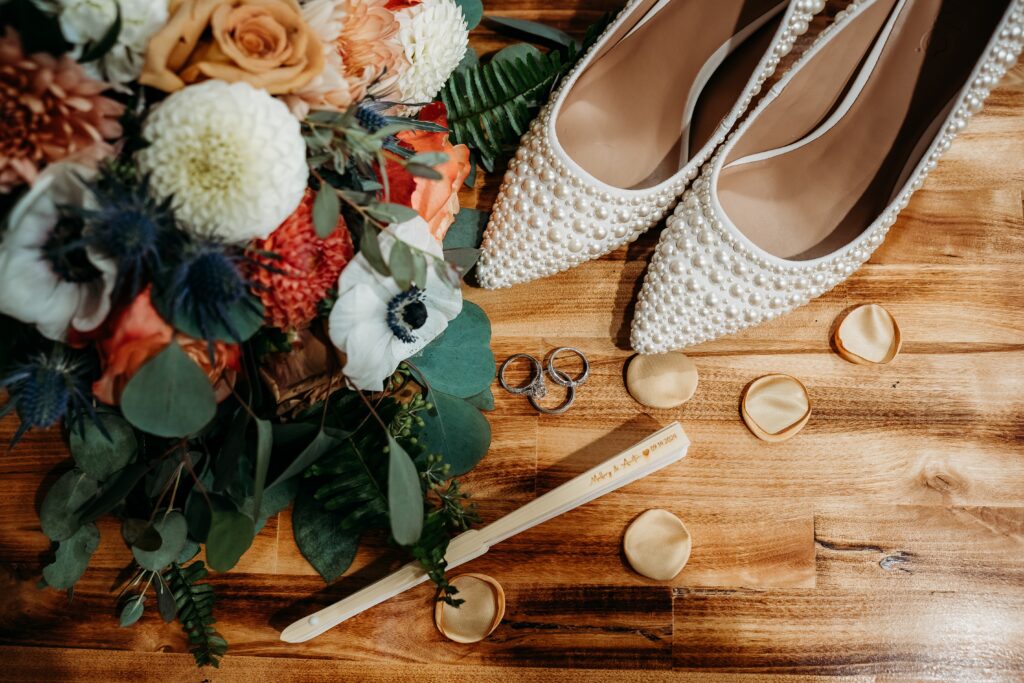 wedding flat lay by arizona wedding photographer, with poppy flowers, dahlia and orange rose bouquet