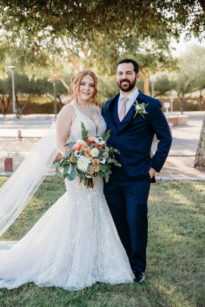 bride and groom posing ideas, arizona wedding photographer, groom in navy blue tux, bride in plunge neck line