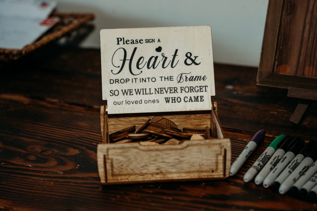 wedding details guest book, signing a wood heart guest book