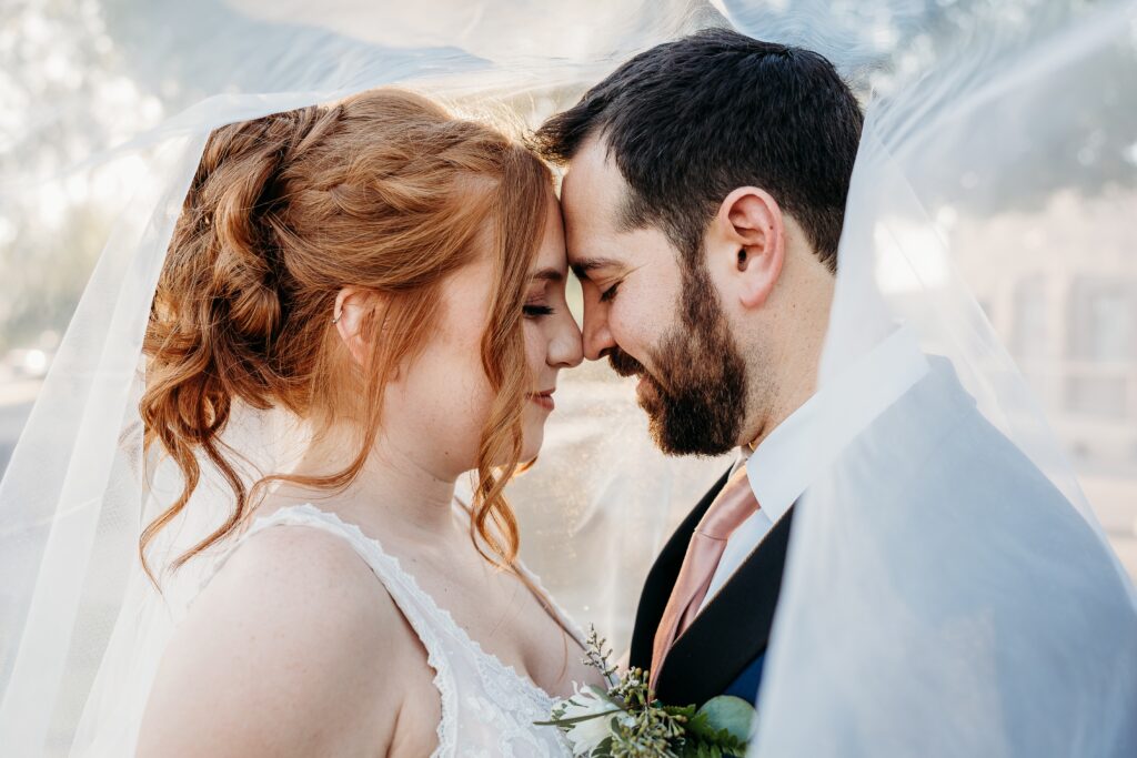 bride and groom posing ideas, arizona wedding photographer, groom in navy blue tux, bride in plunge neck line