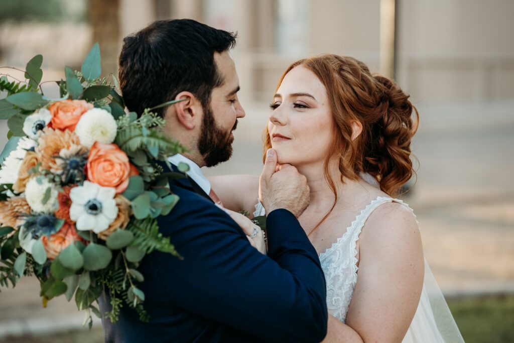 bride and groom posing ideas, arizona wedding photographer, groom in navy blue tux, bride in plunge neck line