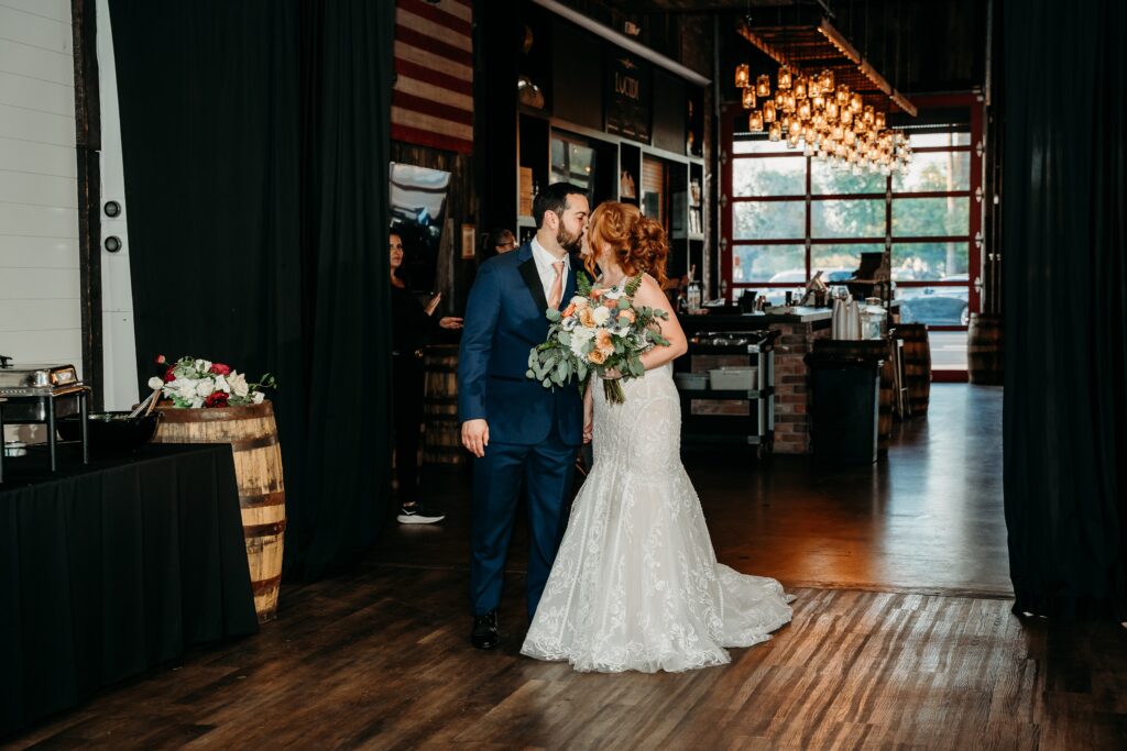 bride and groom entering reception at the fire house event center
