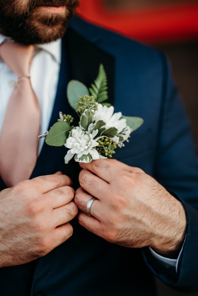 groom and simple white flower corsage, wedding details