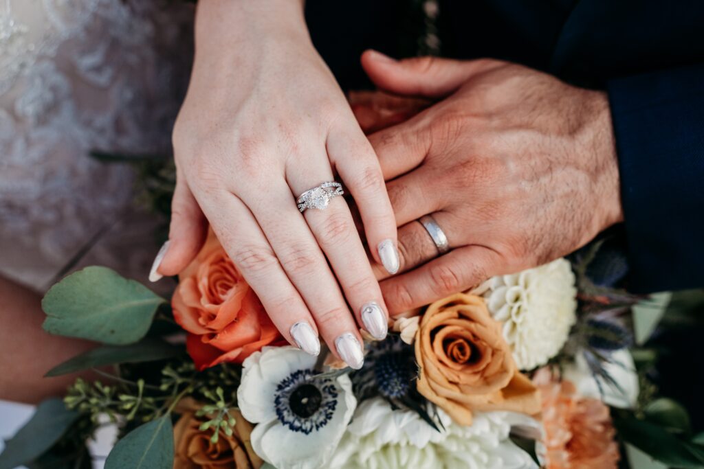 bride and groom ring shot over wedding bouquet