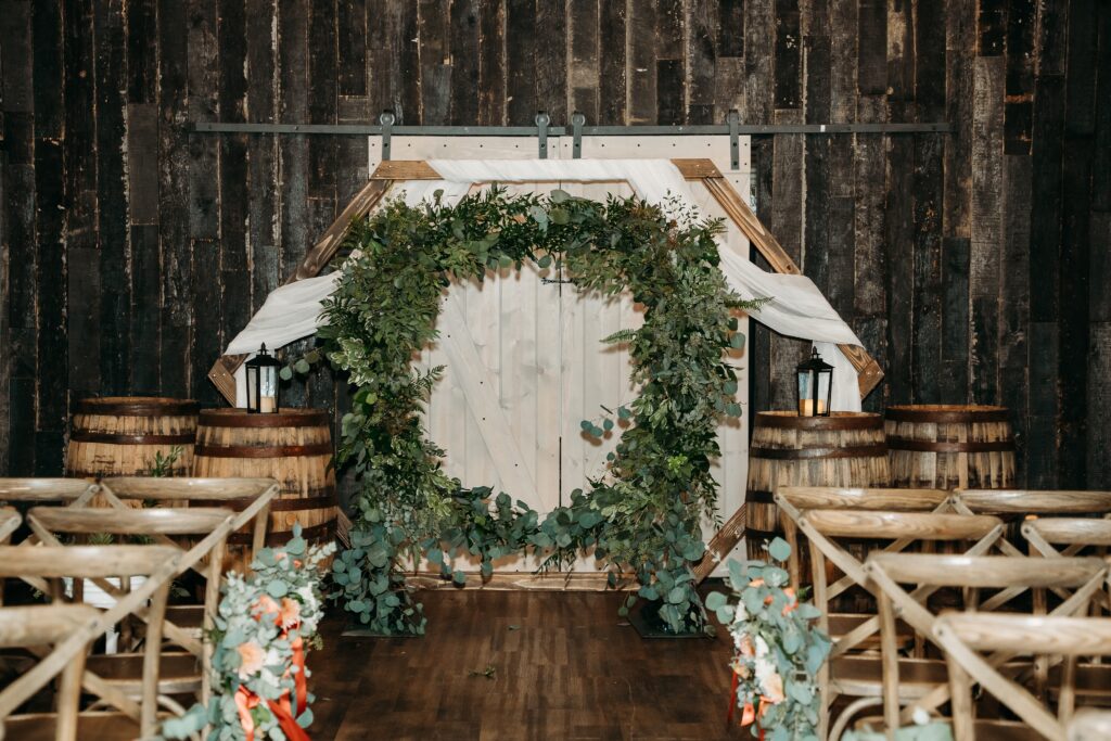 fire house event center ceremony, barnwood and green floral ring, wedding details, arizona wedding photographer