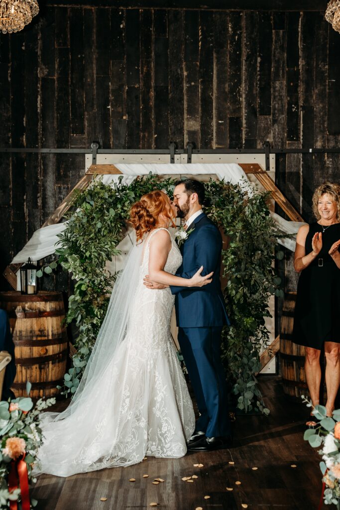 fire house event center ceremony, bride and groom end of ceremony kiss, arizona wedding photographer