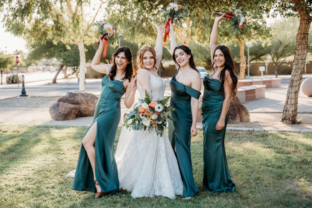 bride and bridesmaid throwing up bouquet, bridesmaids in deep green long dress, arizona wedding photographer