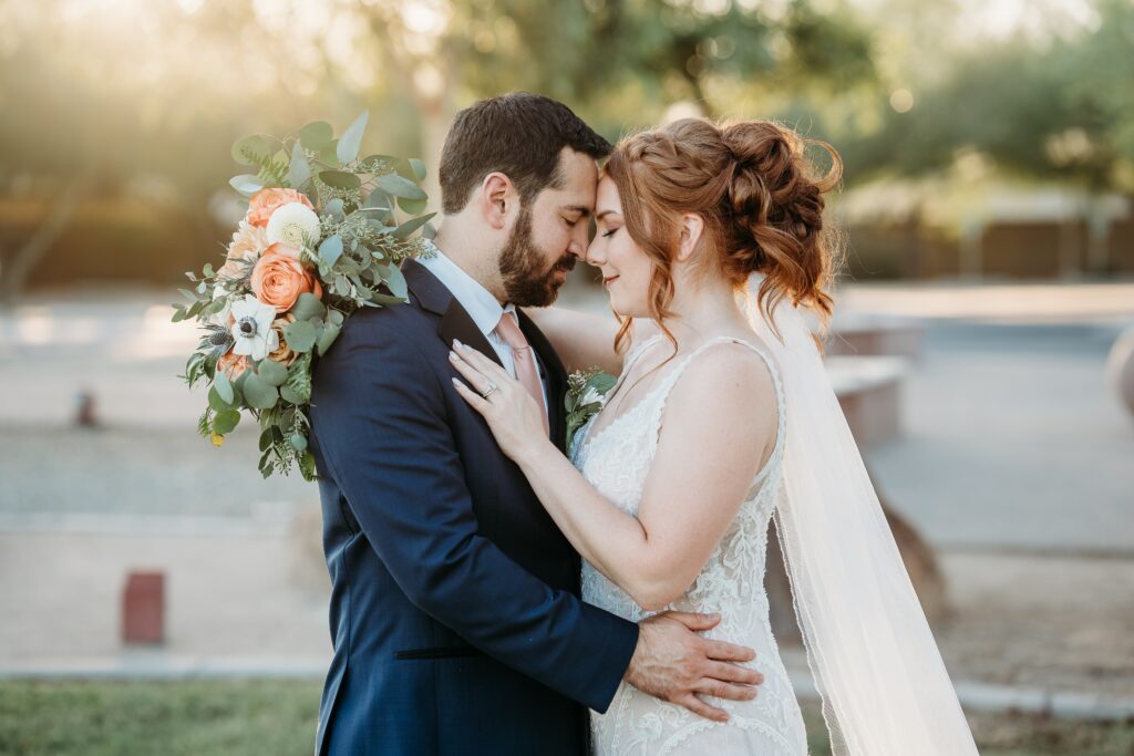 bride and groom posing ideas, arizona wedding photographer, groom in navy blue tux, bride in plunge neck line