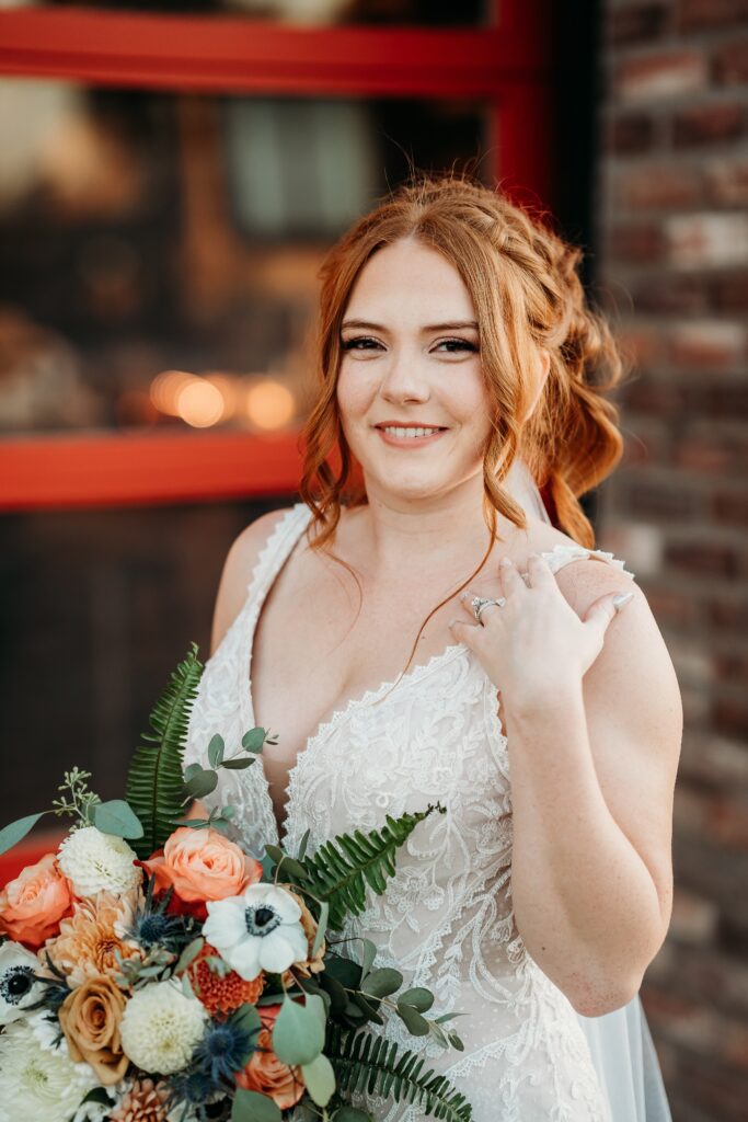 bride posing ideas, bride in deep plunge neck line, updo with poppy and rose bouquet