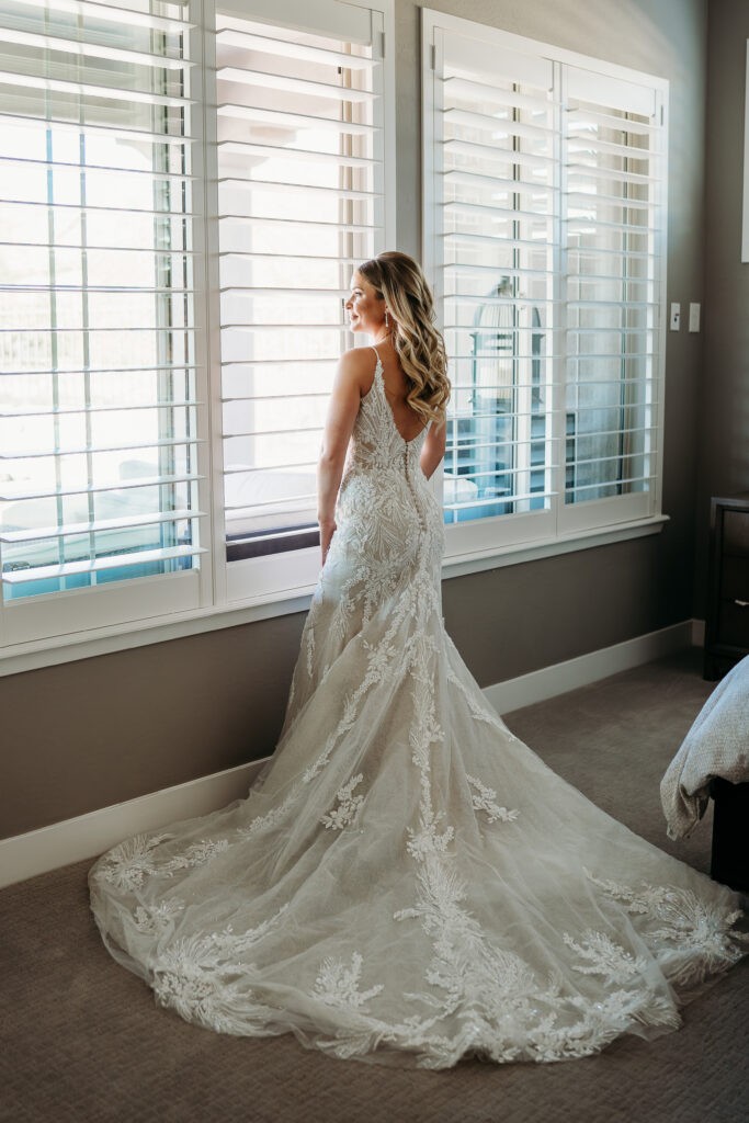 Bride Posing Ideas, bride getting ready, bride in long train, moody bridal portraits, bride in intricate wedding dress, arizona wedding photographer