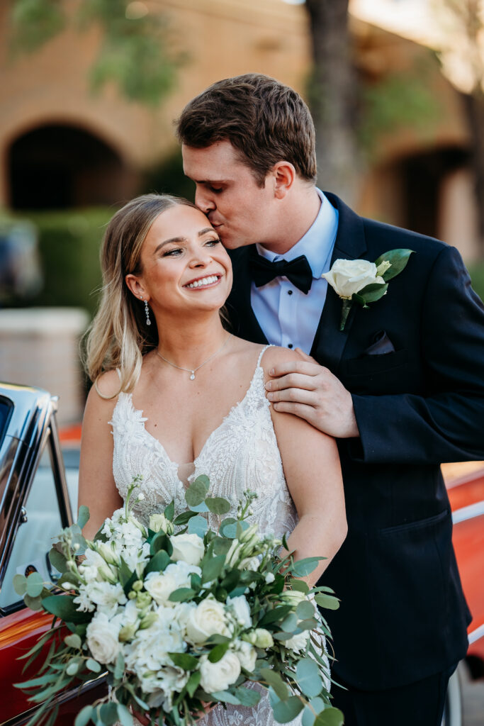 Bride and Groom Posing Ideas, groom kissing brides temple, arizona wedding photographer,bride and groom with red classic car
