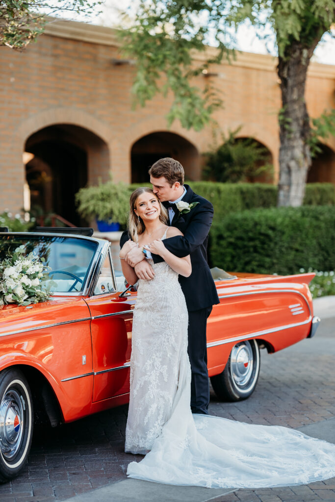 Bride and Groom Posing Ideas, groom kissing brides temple, arizona wedding photographer,bride and groom with red classic car